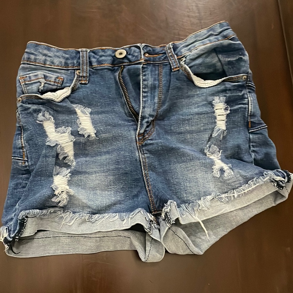 I’m selling these high rise shorts with rips on them.
